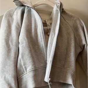 New without tags. Never worn. Gray lululemon cropped sweater with hood. Size 12